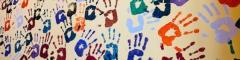 hands covered in paint on a wall